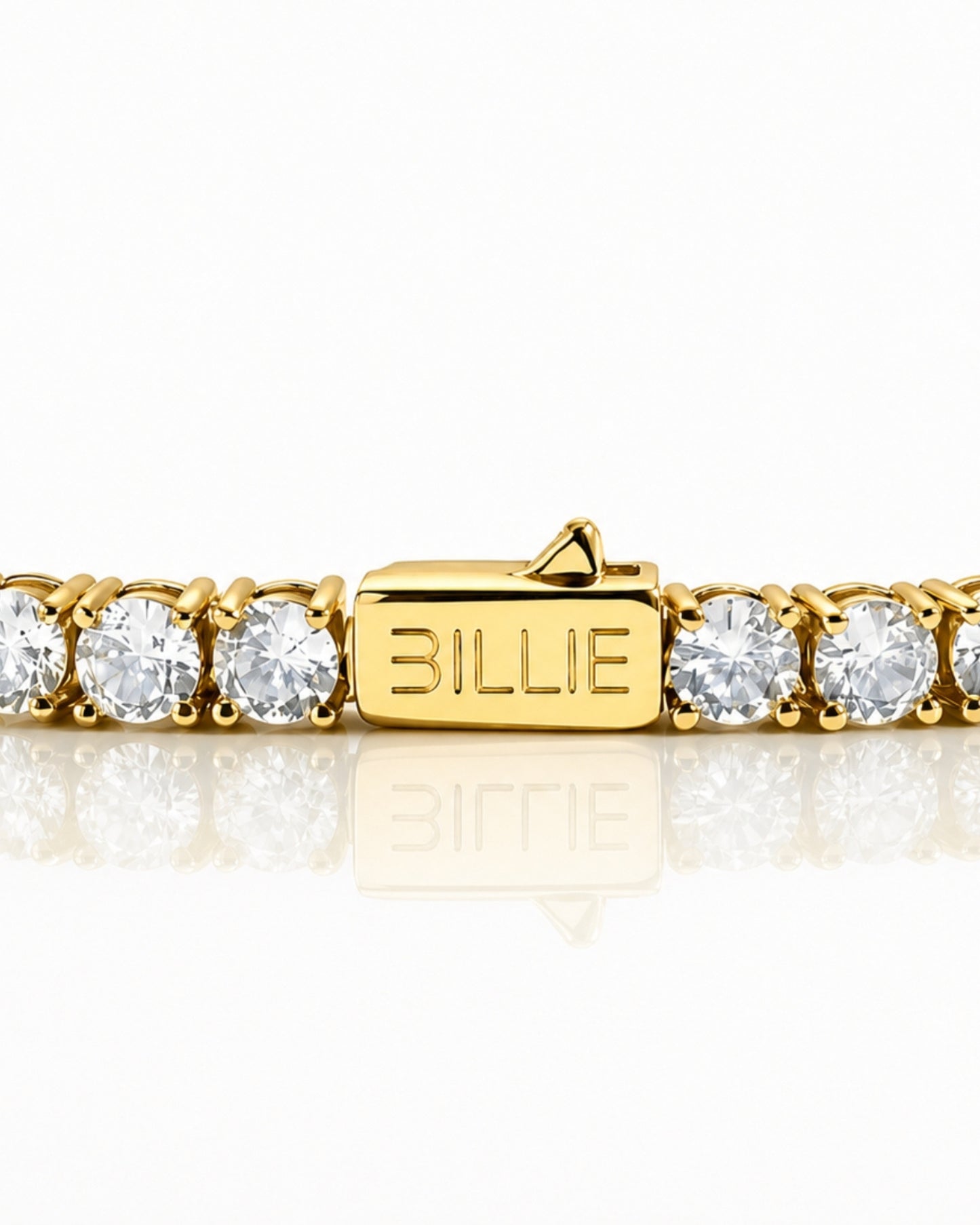 Gold bracelet with clear stones and a clasp marked 'BILLIE'.
