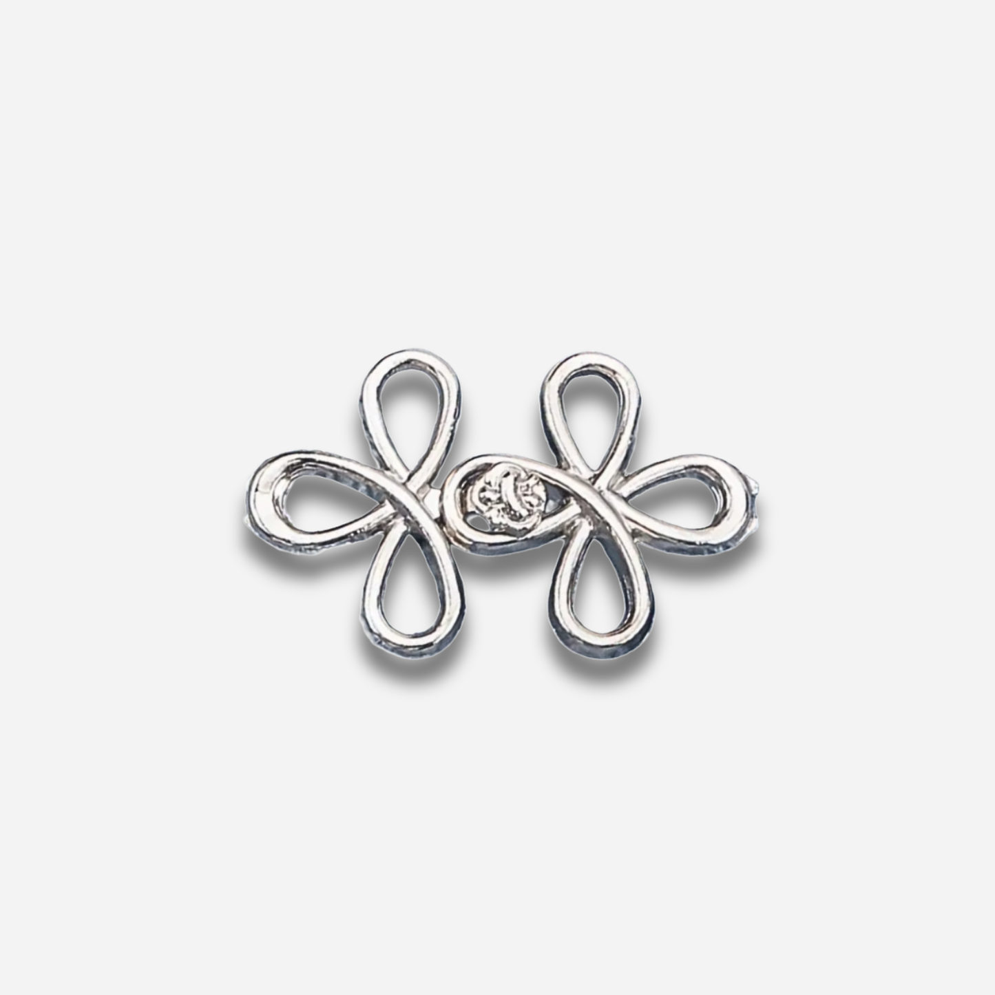 Silver sculpted waist knot on a light gray background