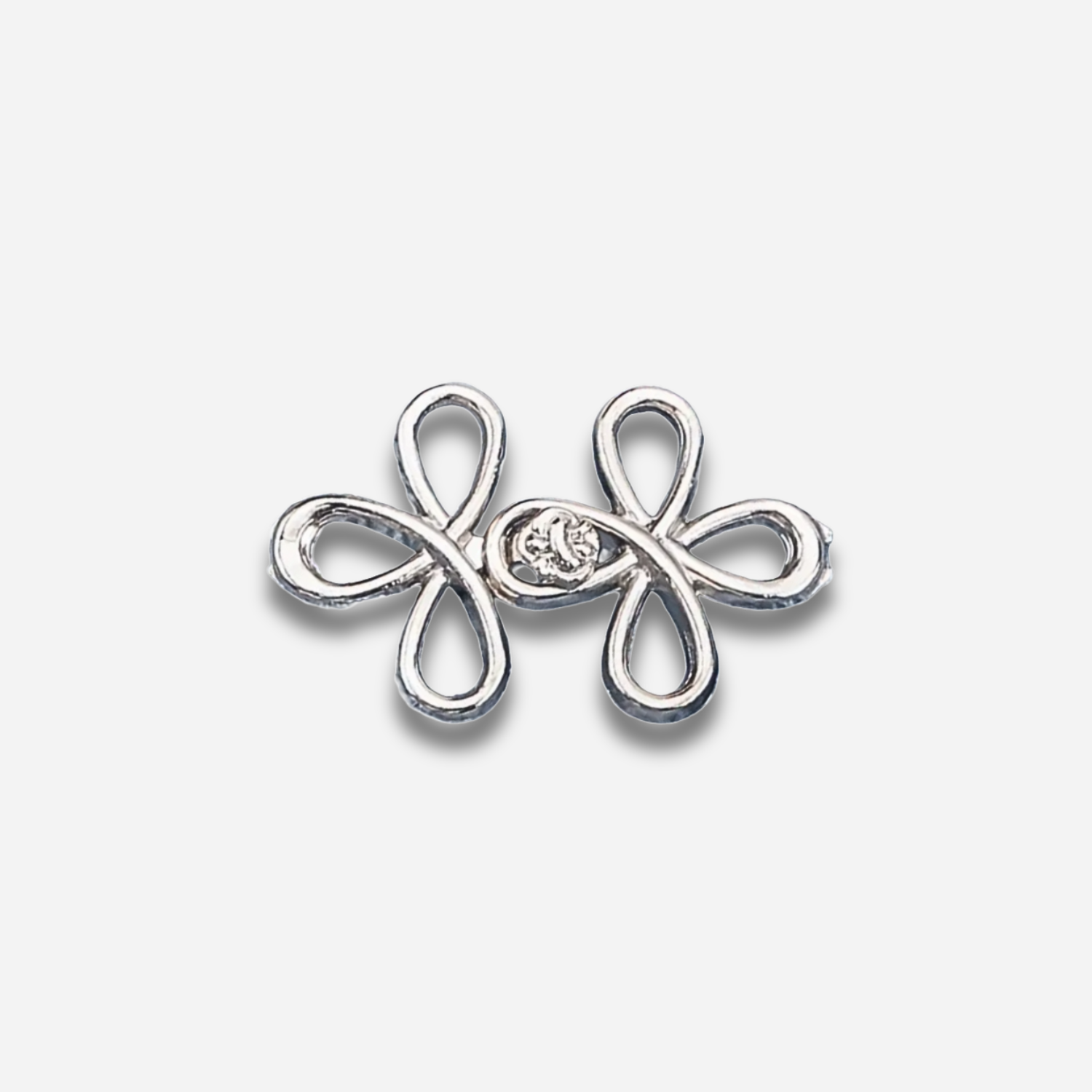 Silver sculpted waist knot on a light gray background