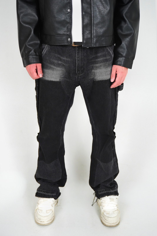Person wearing a black leather jacket, black jeans, and white sneakers on a white background