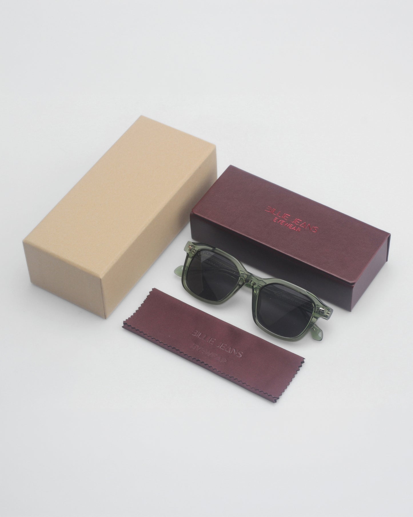 Sunglasses on a plain background with a brown box and a beige box.