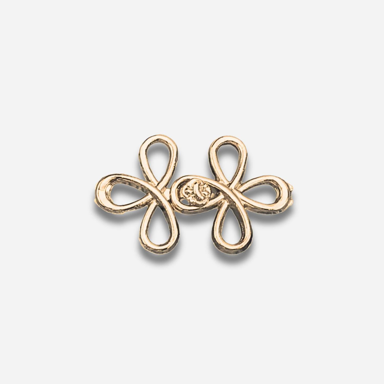 Gold sculpted waist knot on a light gray background