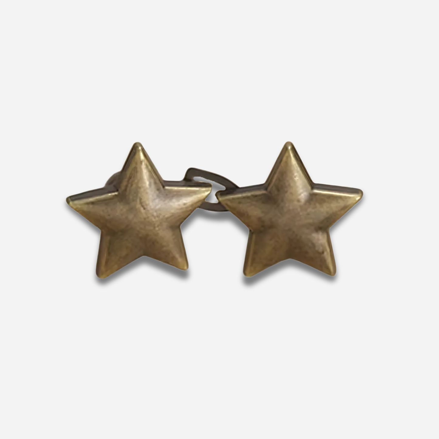Pair of antique gold star waist knots on a white background