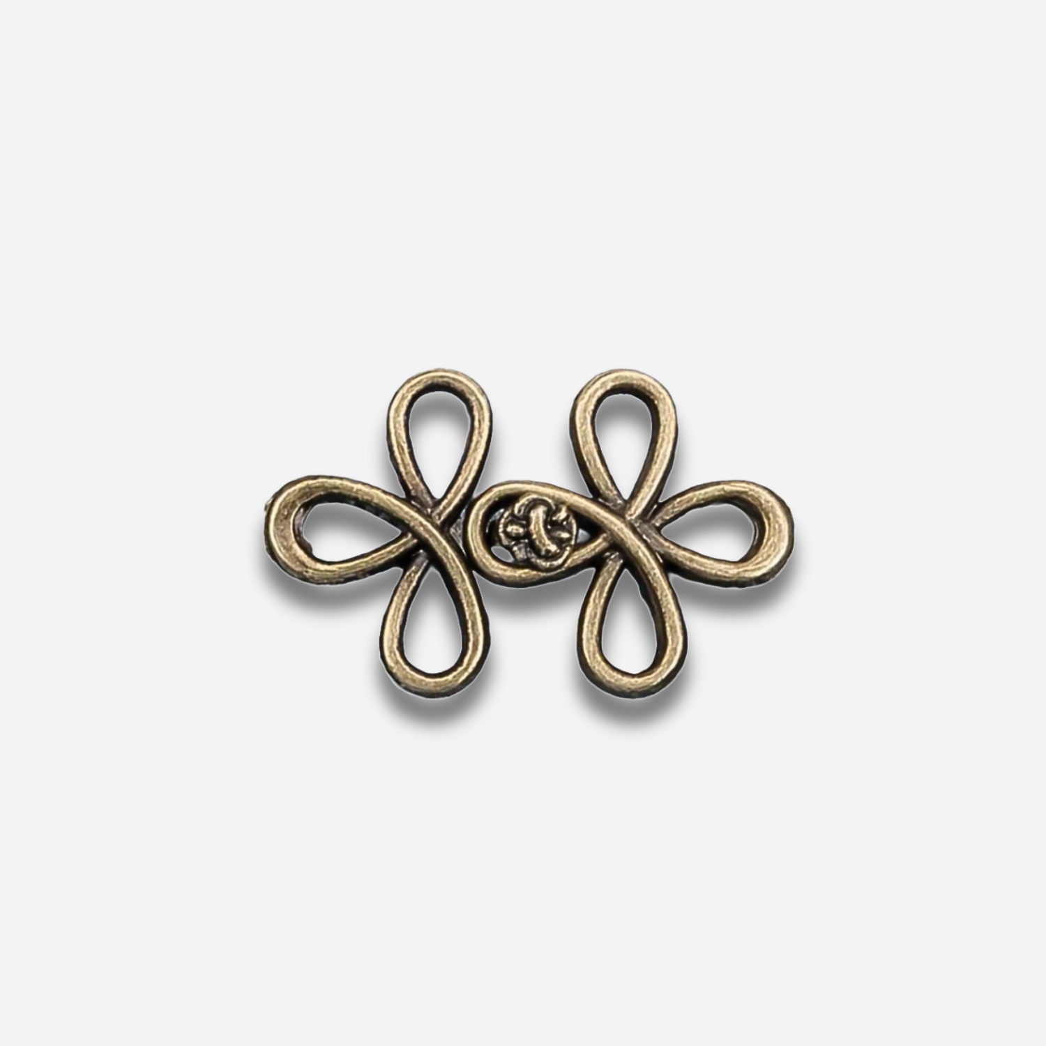 Antique gold sculpted waist knot on a light gray background