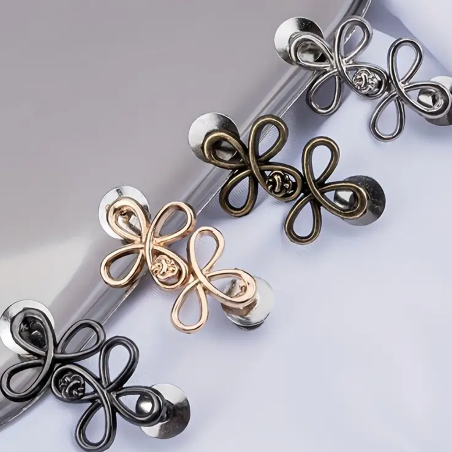 Four butterfly-shaped waist knots in different colors on a light gray background