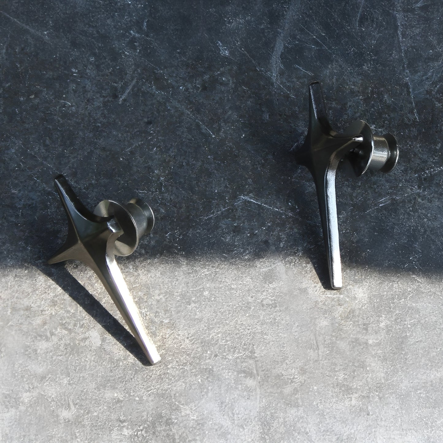 Two metal objects on a textured surface