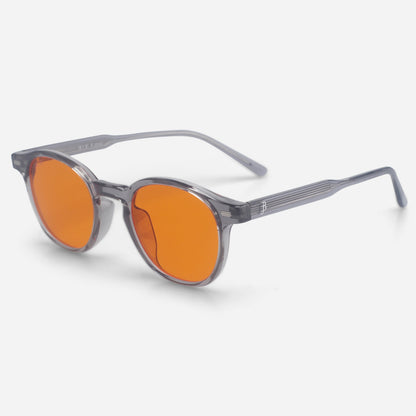 Sunglasses with orange lenses and gray frame on a white background