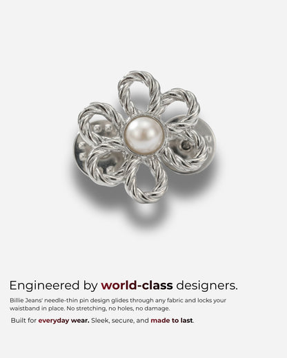 Silver flower-shaped pin with a pearl center on a plain background.