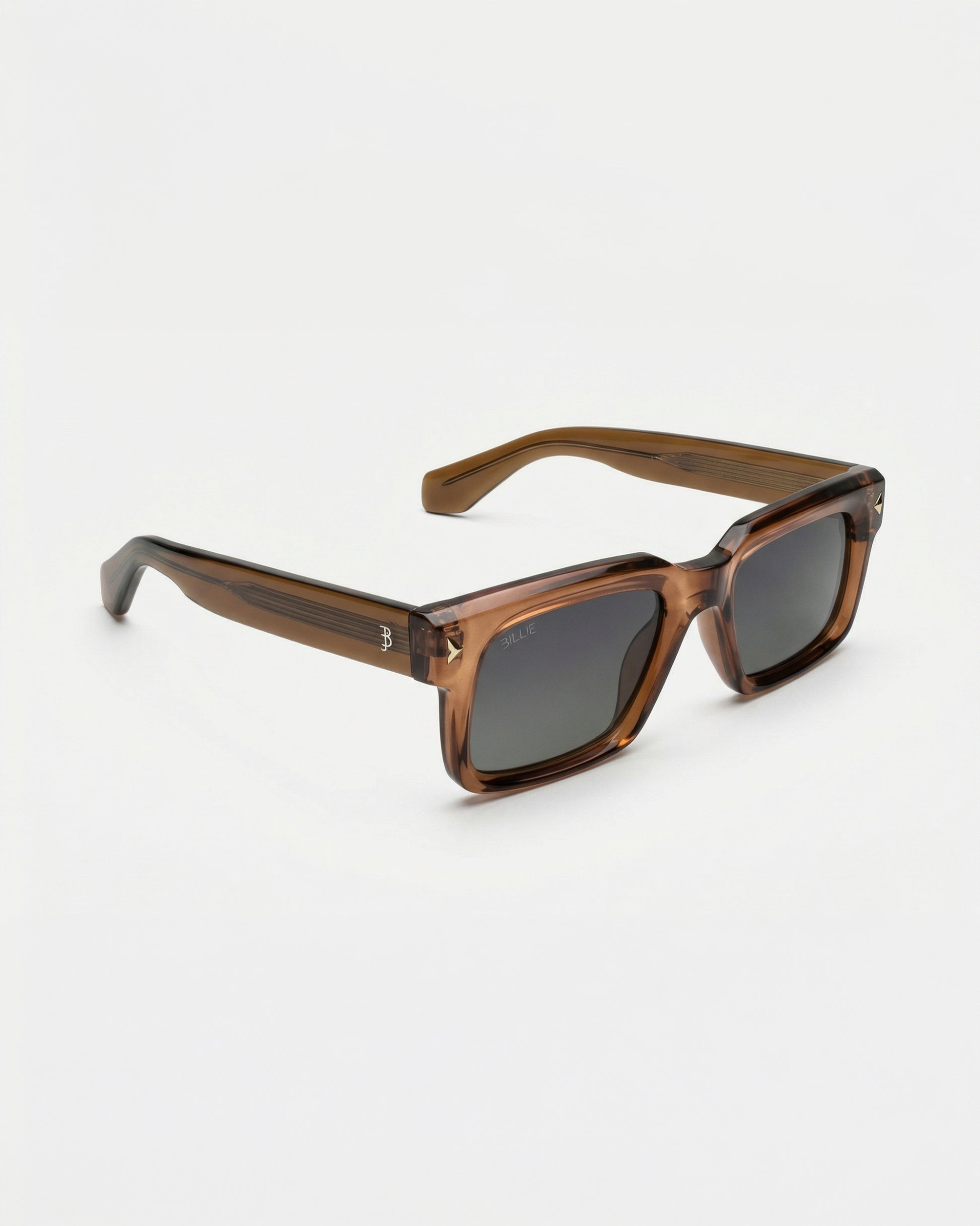 Brown sunglasses with dark lenses on a plain background