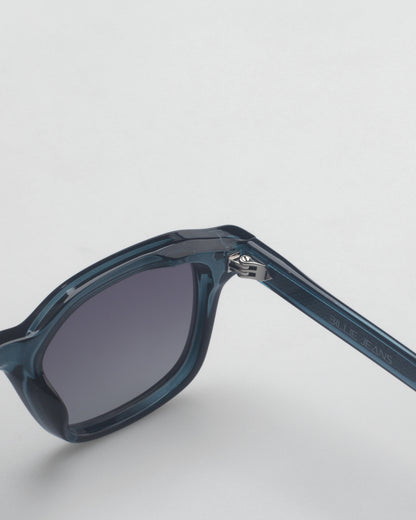 Blue sunglasses with gradient lenses on a plain background