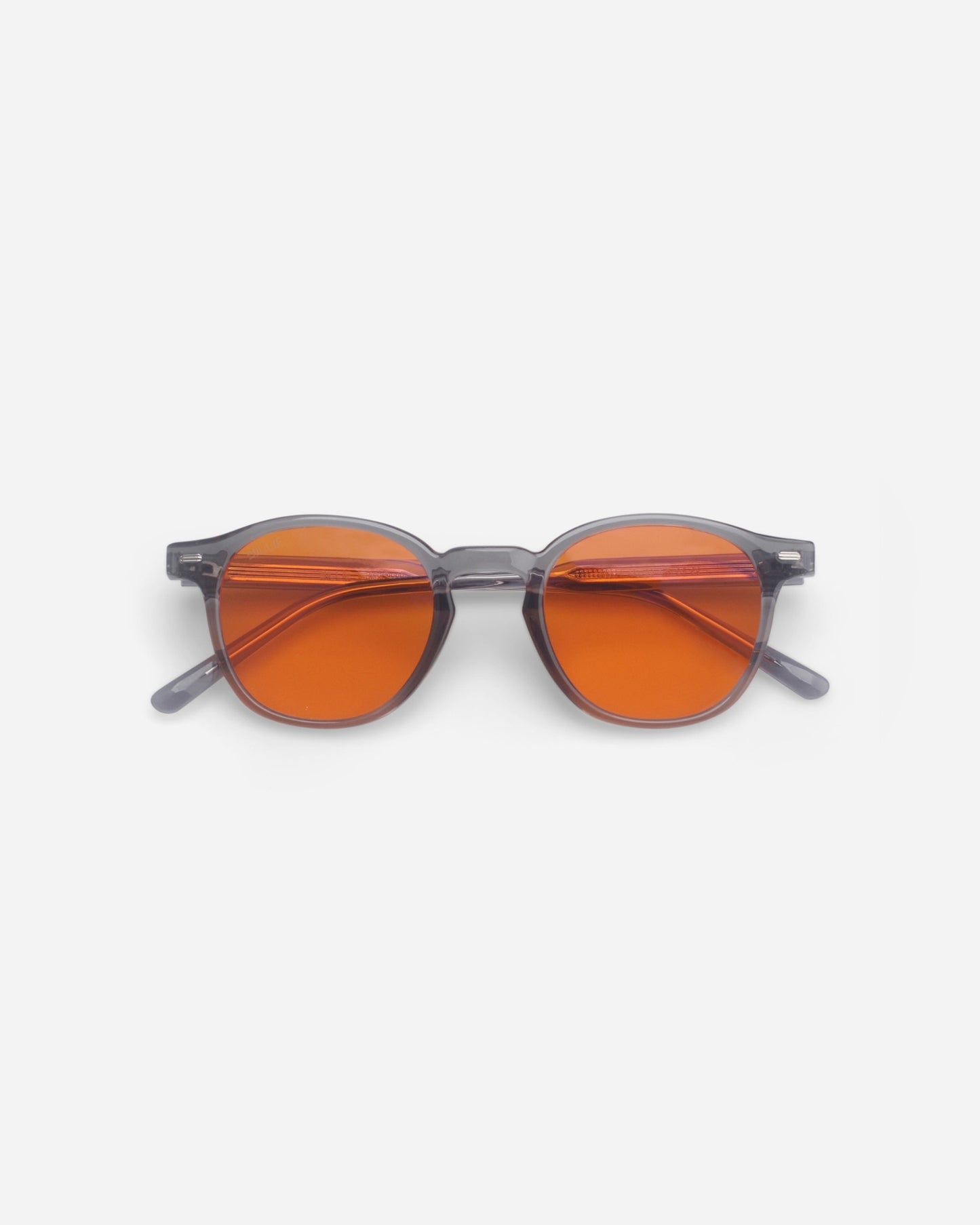 Round sunglasses with orange lenses on a plain white background
