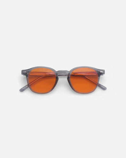 Round sunglasses with orange lenses on a plain white background