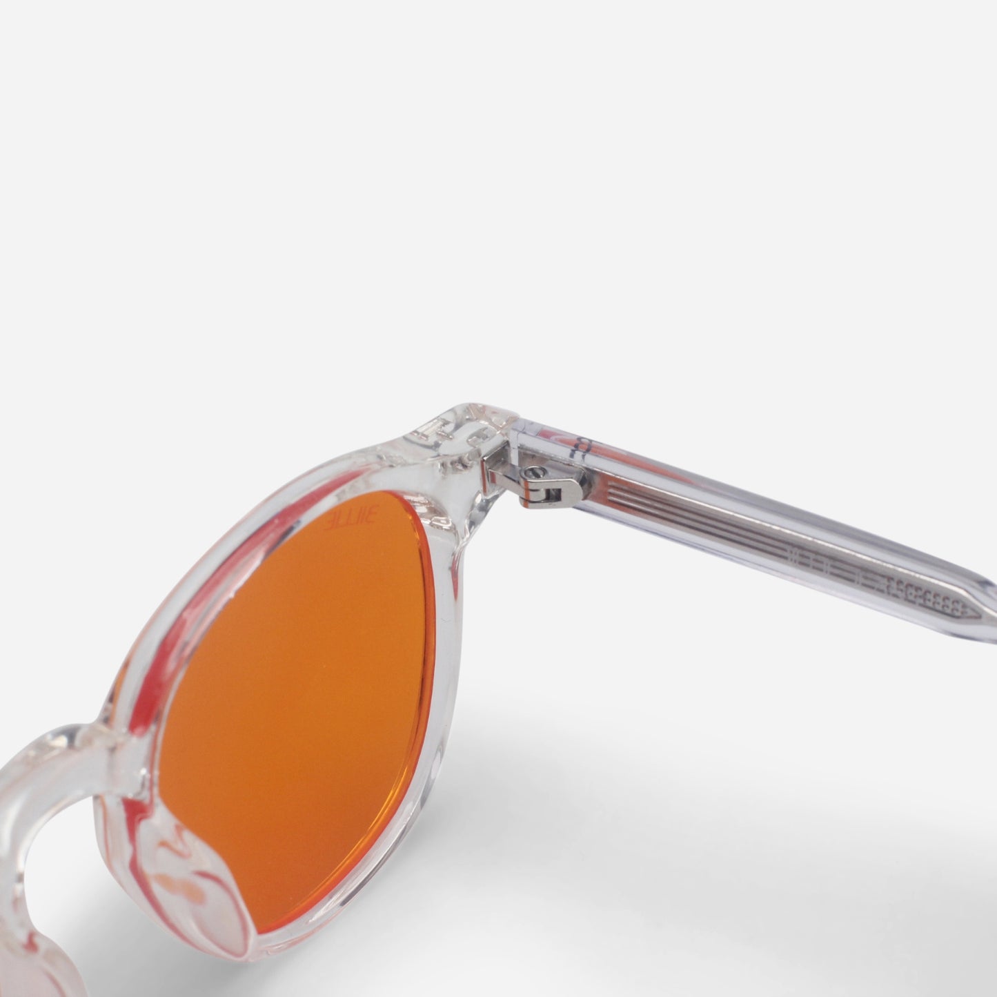 Blue light glasses with orange lenses and clear frame on a white background