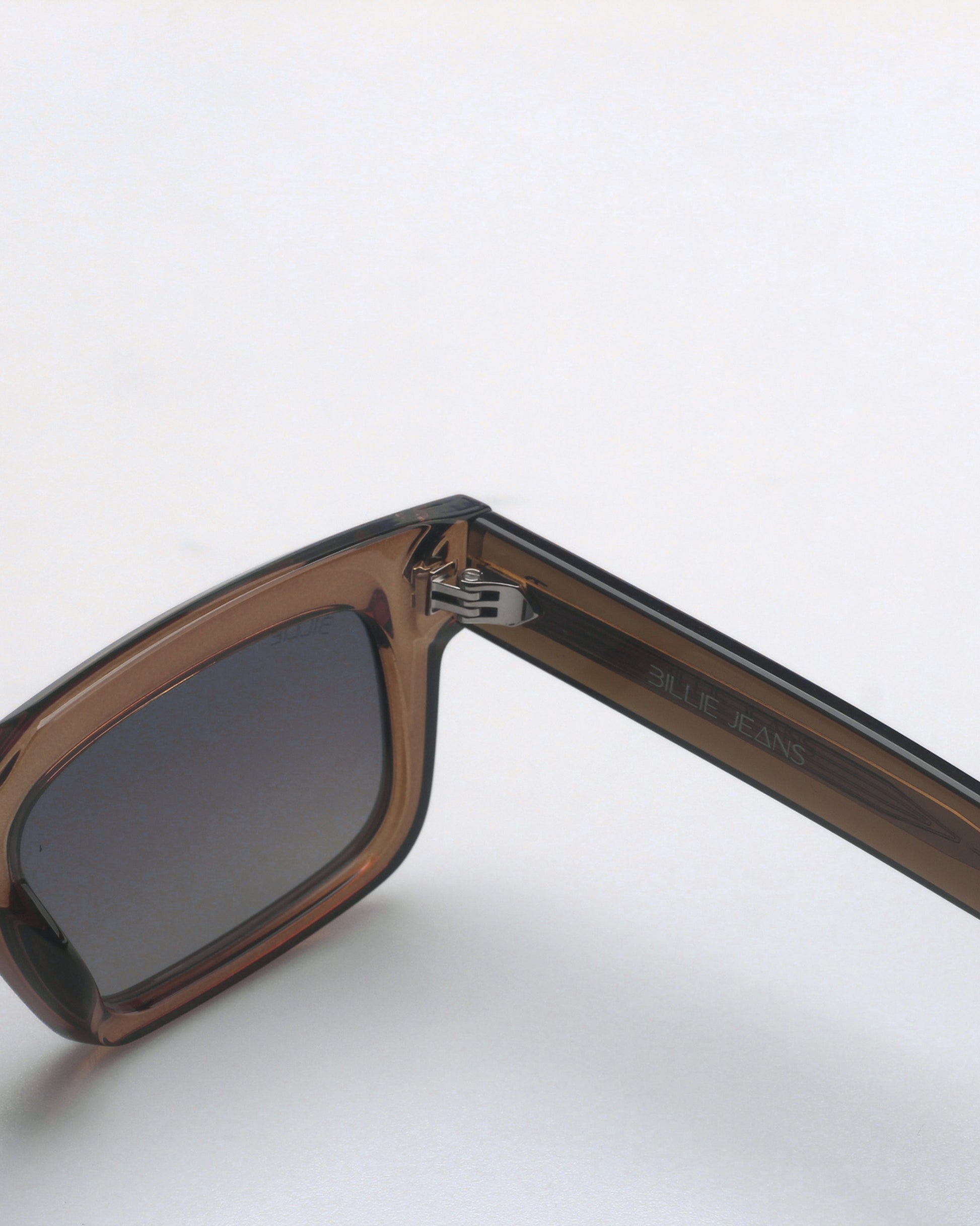 Brown sunglasses with a dark lens and a visible logo on the arm.