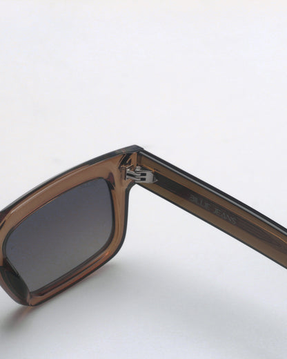 Brown sunglasses with a dark lens and a visible logo on the arm.