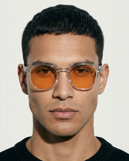Man wearing the Billie Blue Light Glasses in clear with orange lenses, front view