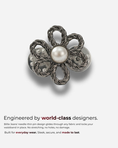 Metal flower-shaped pin with a pearl center on a plain background.