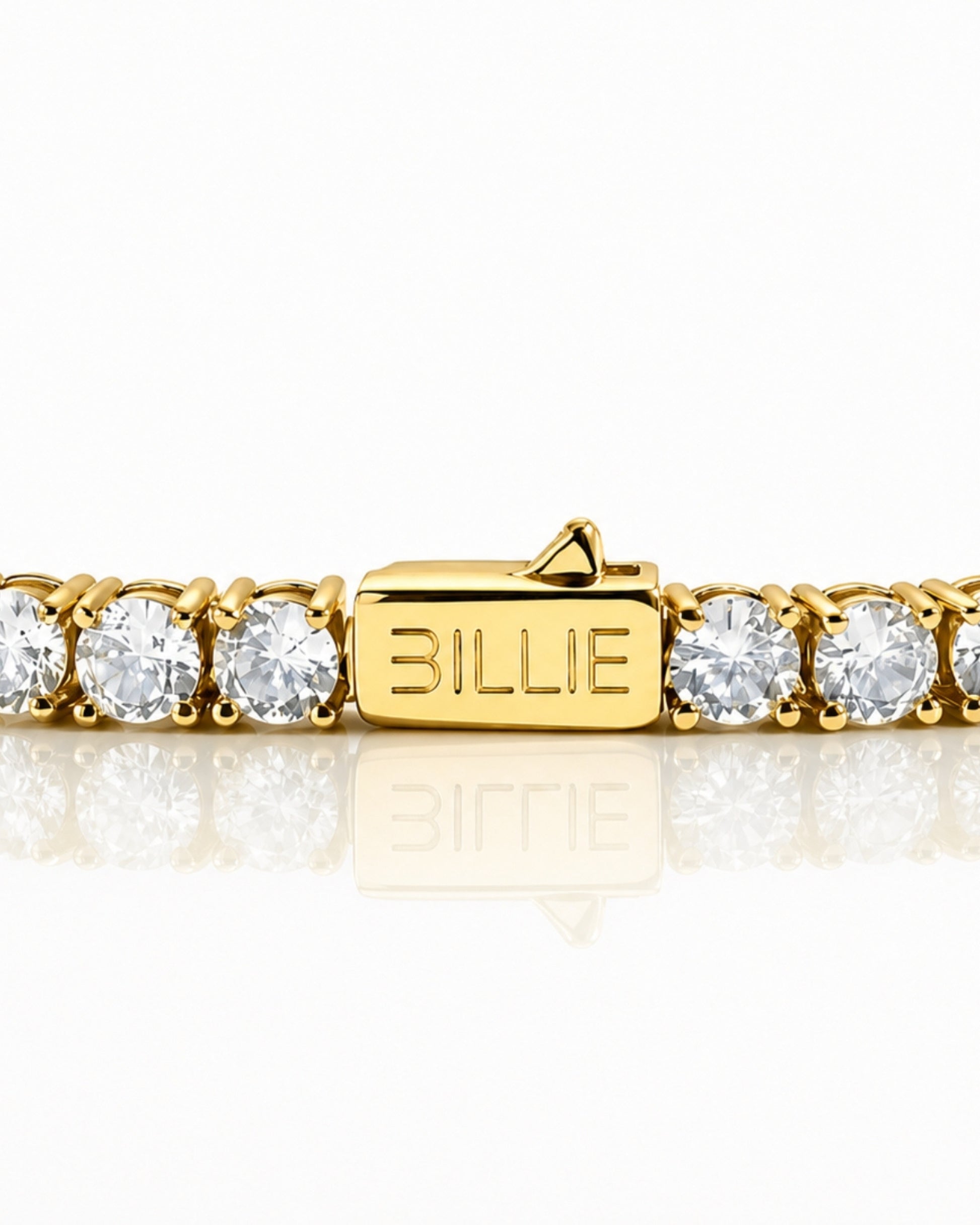 Gold bracelet with clear stones and a clasp marked 'BILLIE'.