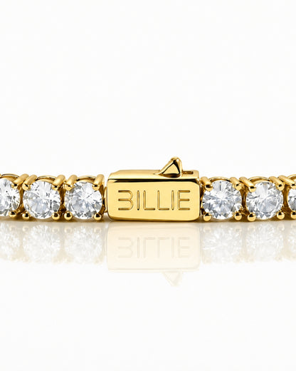 Gold bracelet with clear stones and a clasp marked 'BILLIE'.