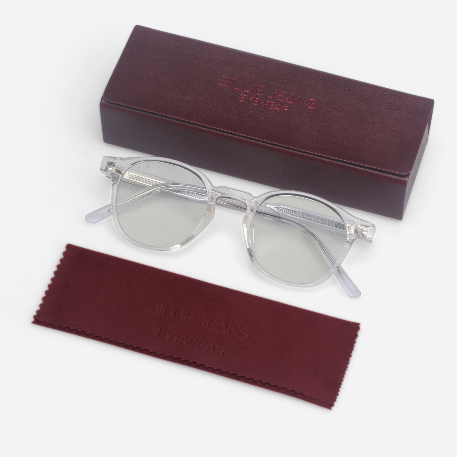 Clear sunglasses with a maroon case and cleaning cloth on a white background