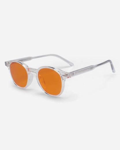 Clear frame sunglasses with orange lenses on a plain background