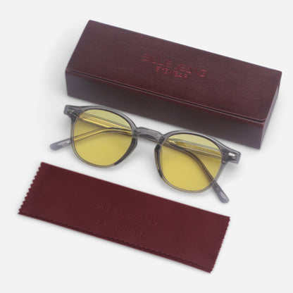 Round sunglasses with yellow lenses and a maroon case on a white background