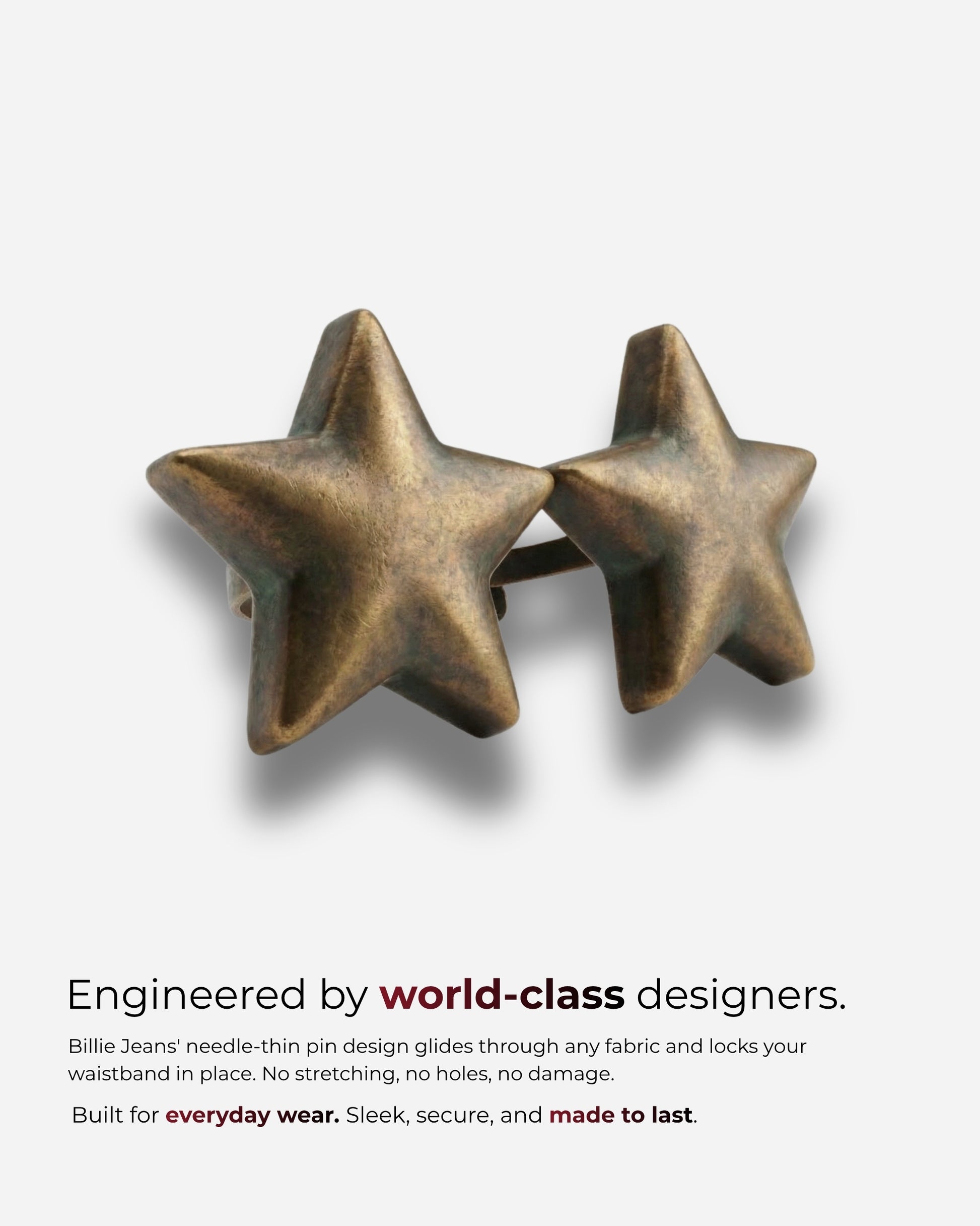 Two bronze star-shaped pins on a plain background.