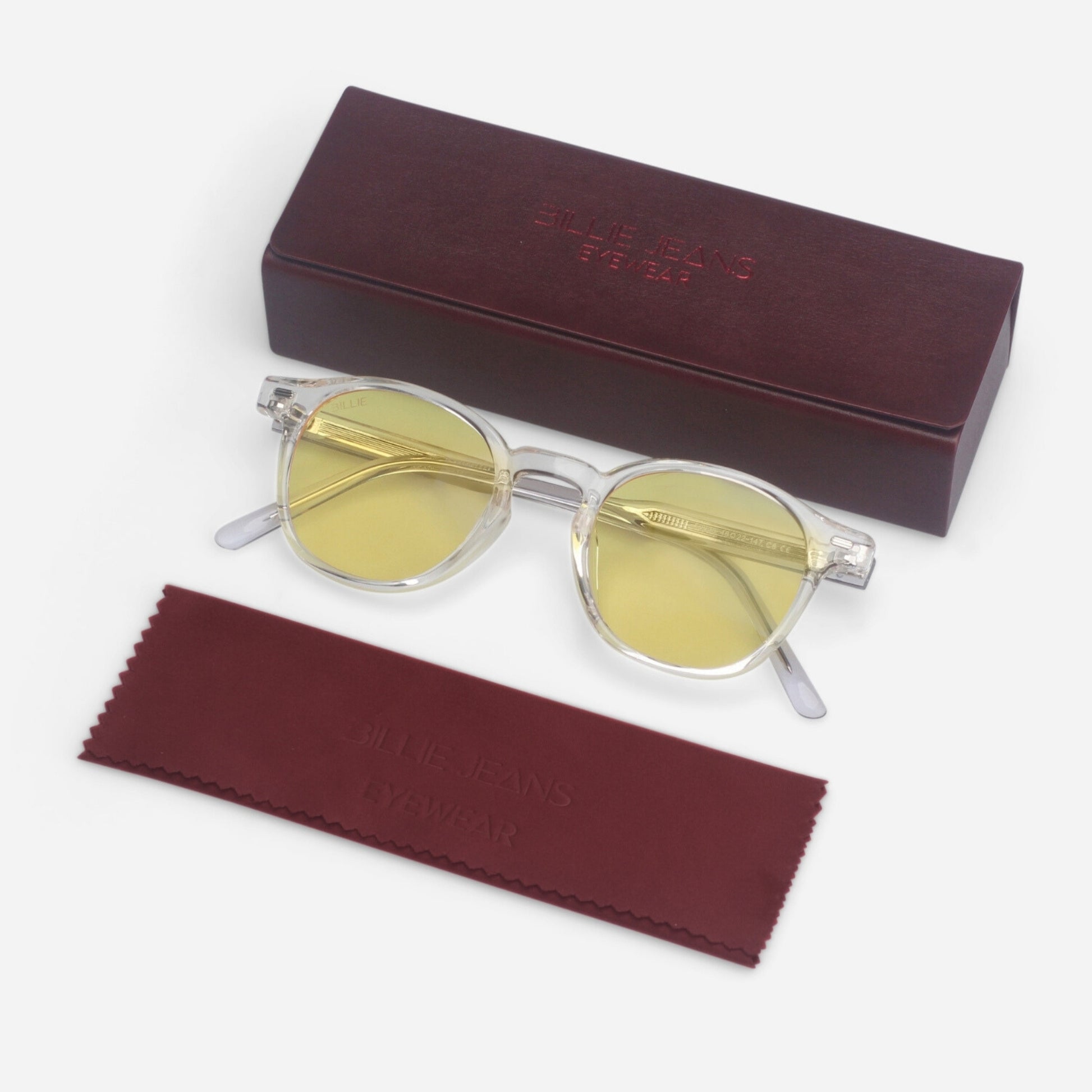 Round sunglasses with yellow lenses and a maroon case on a white background