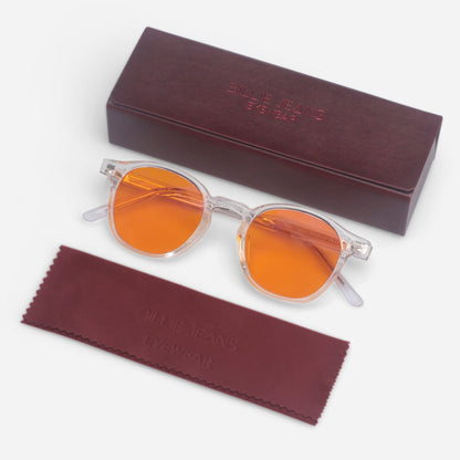 Orange sunglasses with clear frames on a white background, accompanied by a matching case and cleaning cloth.