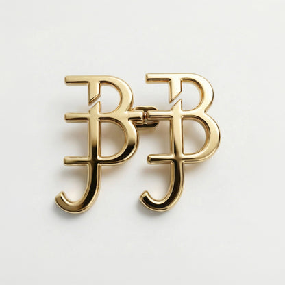 Gold earrings with 'BB' design on a light gray background