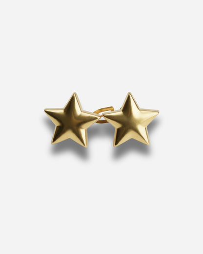 Gold star-shaped earrings on a plain background