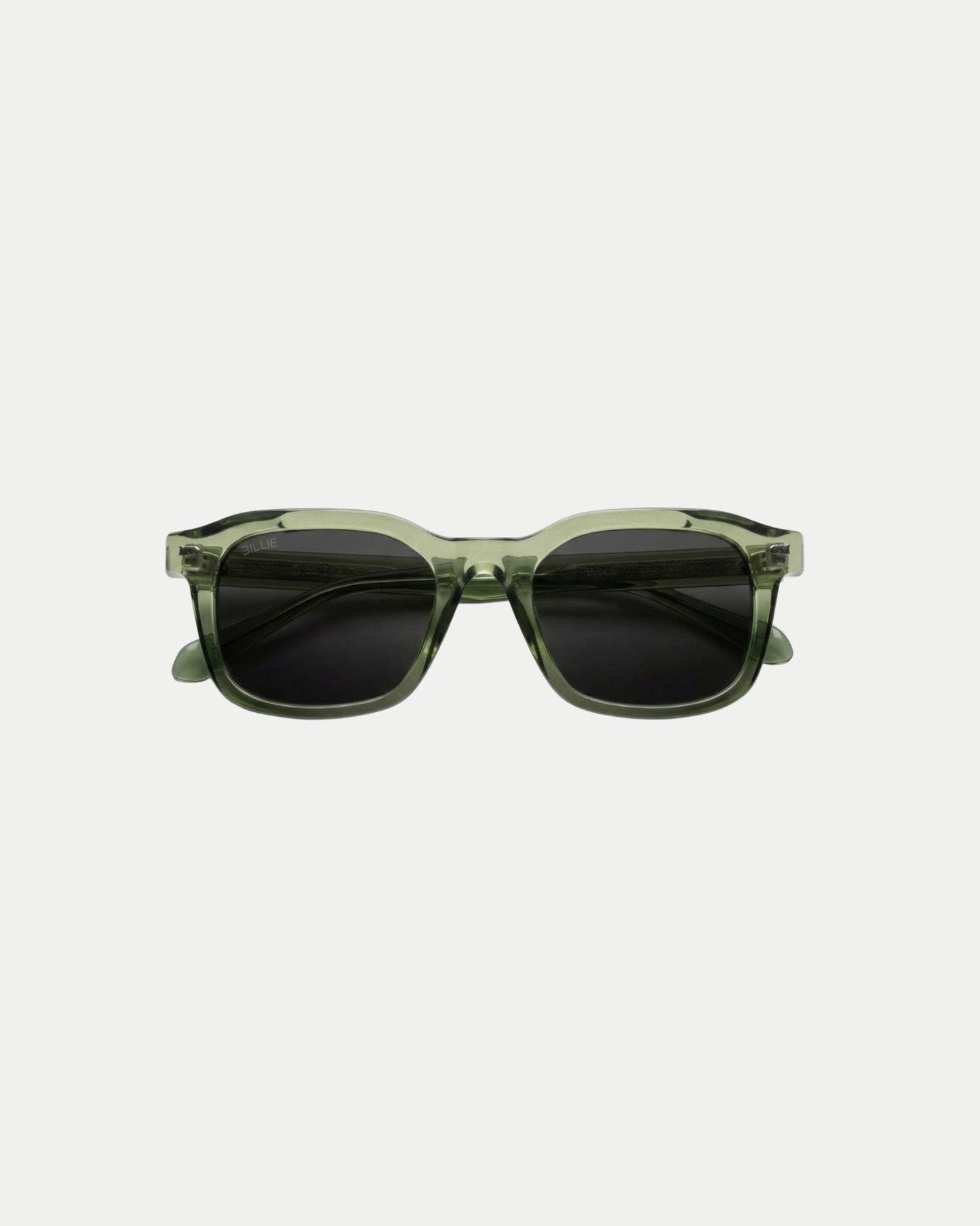 Green sunglasses with dark lenses on a plain background