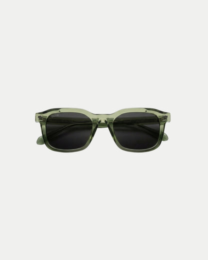Green sunglasses with dark lenses on a plain background