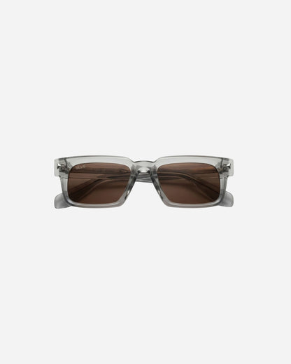 Gray sunglasses with brown lenses on a plain background