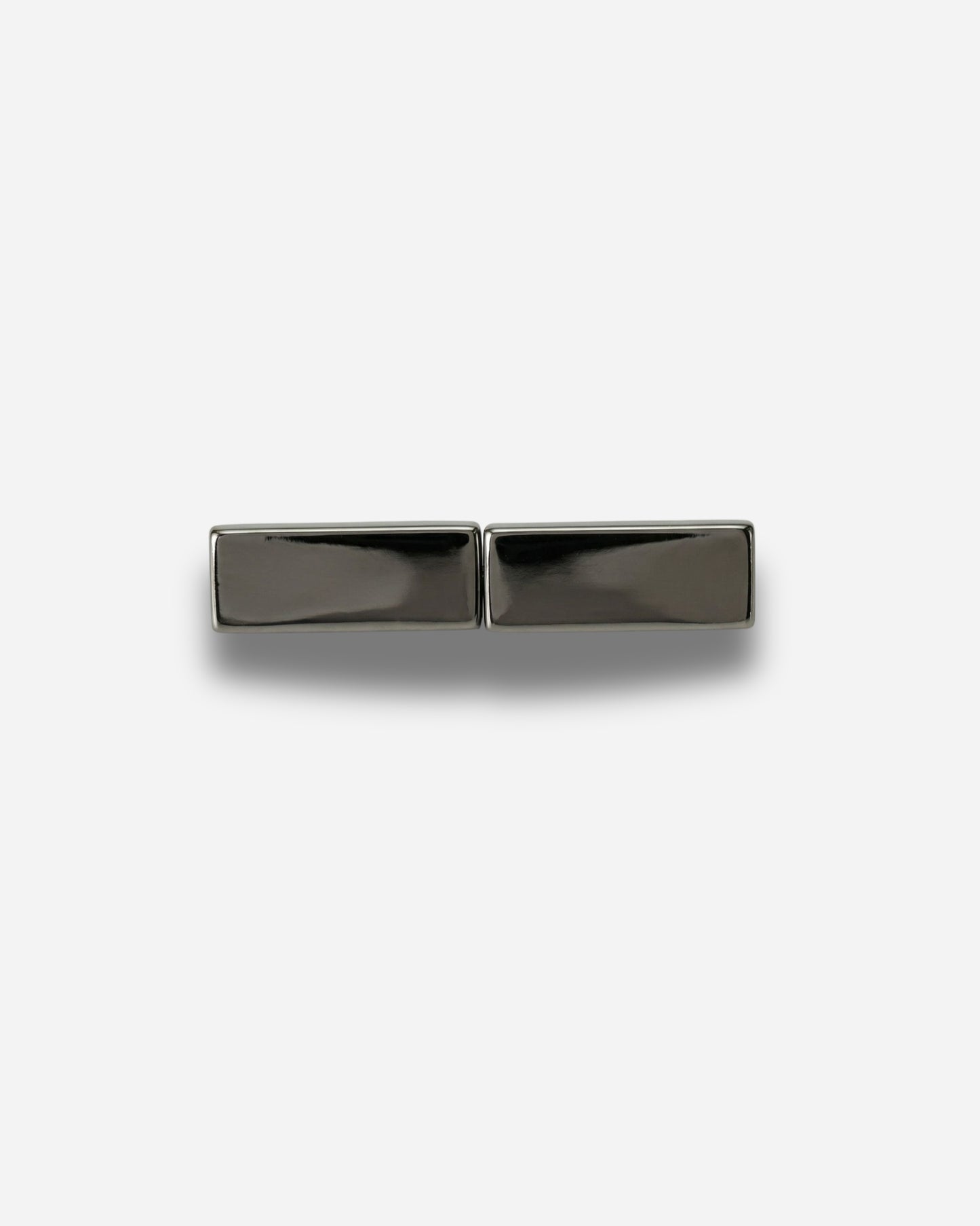 Two rectangular metallic pieces on a plain white background