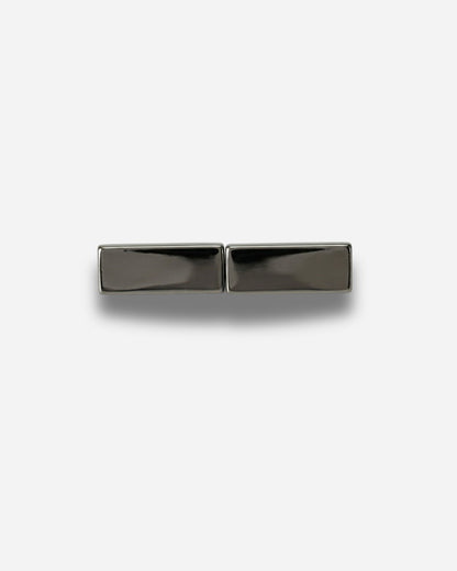Two rectangular metallic pieces on a plain white background