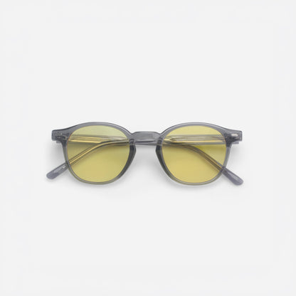Round sunglasses with yellow lenses and gray frames on a white background