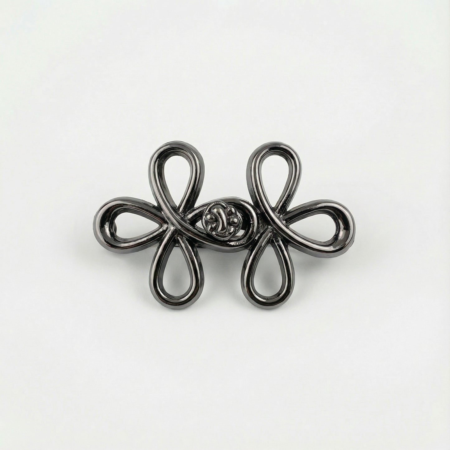 Silver floral brooch on a white background