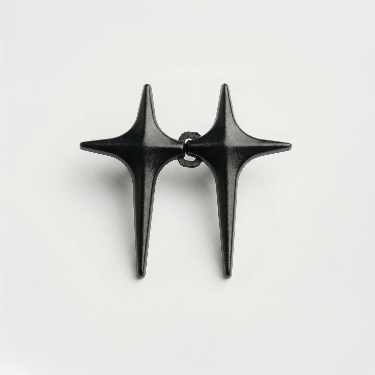 Black star-shaped earrings on a white background