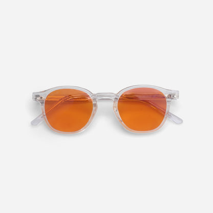 Sunglasses with orange lenses and clear frames on a white background