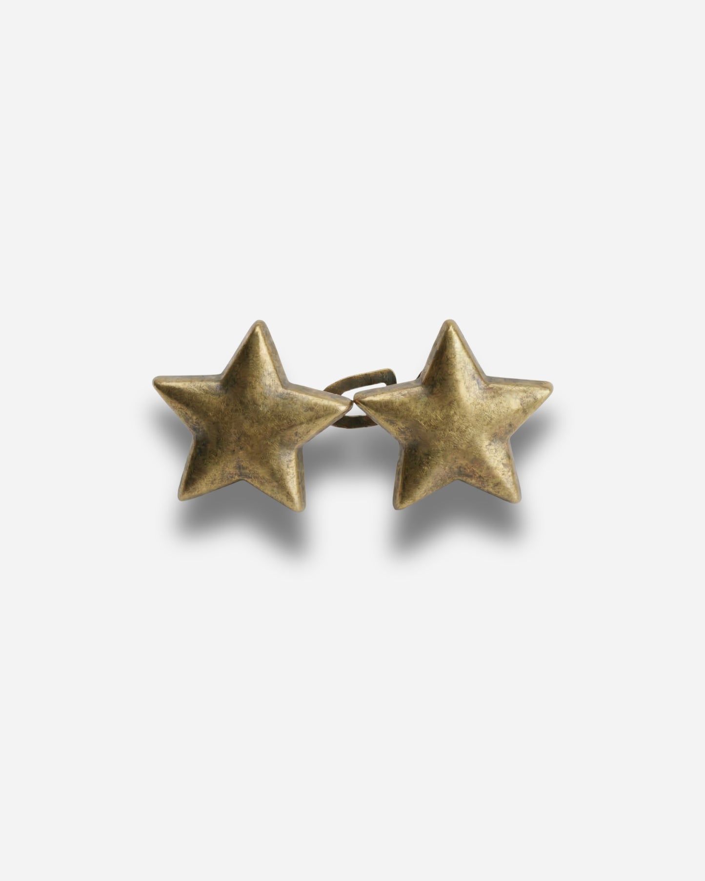 Two star-shaped earrings in a metallic finish on a plain background.