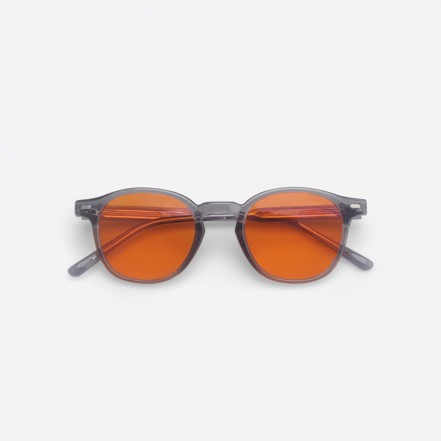 Sunglasses with orange lenses and gray frames on a white background