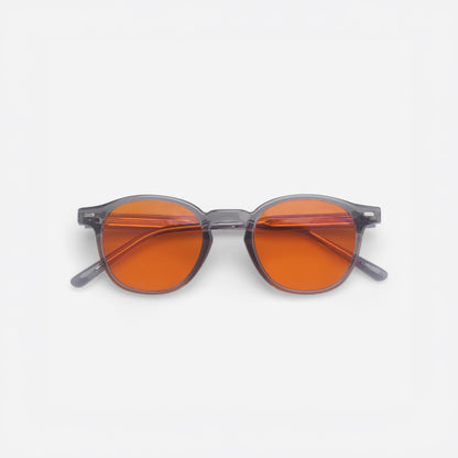 Sunglasses with orange lenses and gray frames on a white background