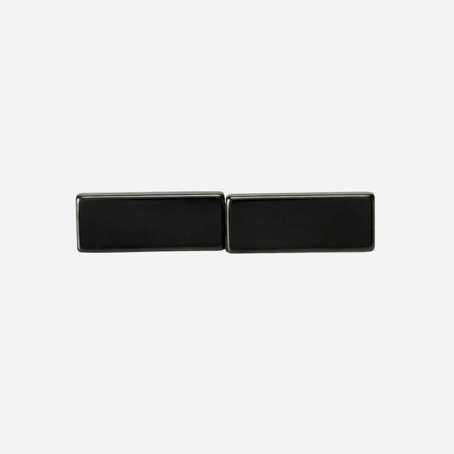 Black rectangular cufflinks on a light gray background