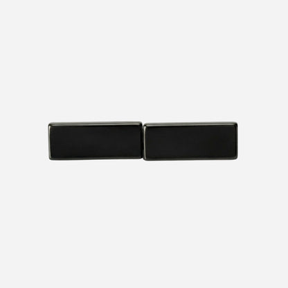 Black rectangular cufflinks on a light gray background