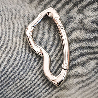 chrome carabiner keychain on denim 