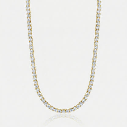 Gold necklace with clear stones on a light gray background
