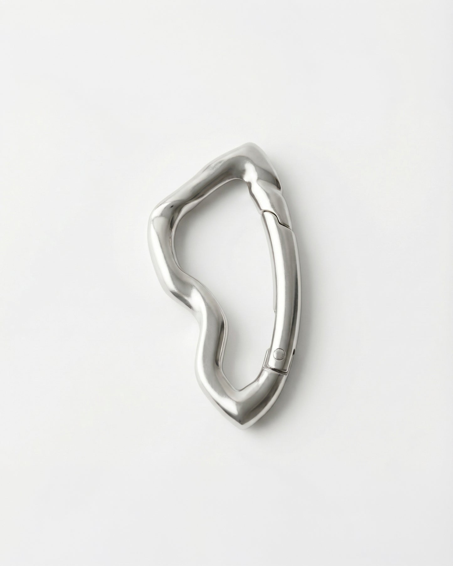 Wavy silver metal clip on a plain white background