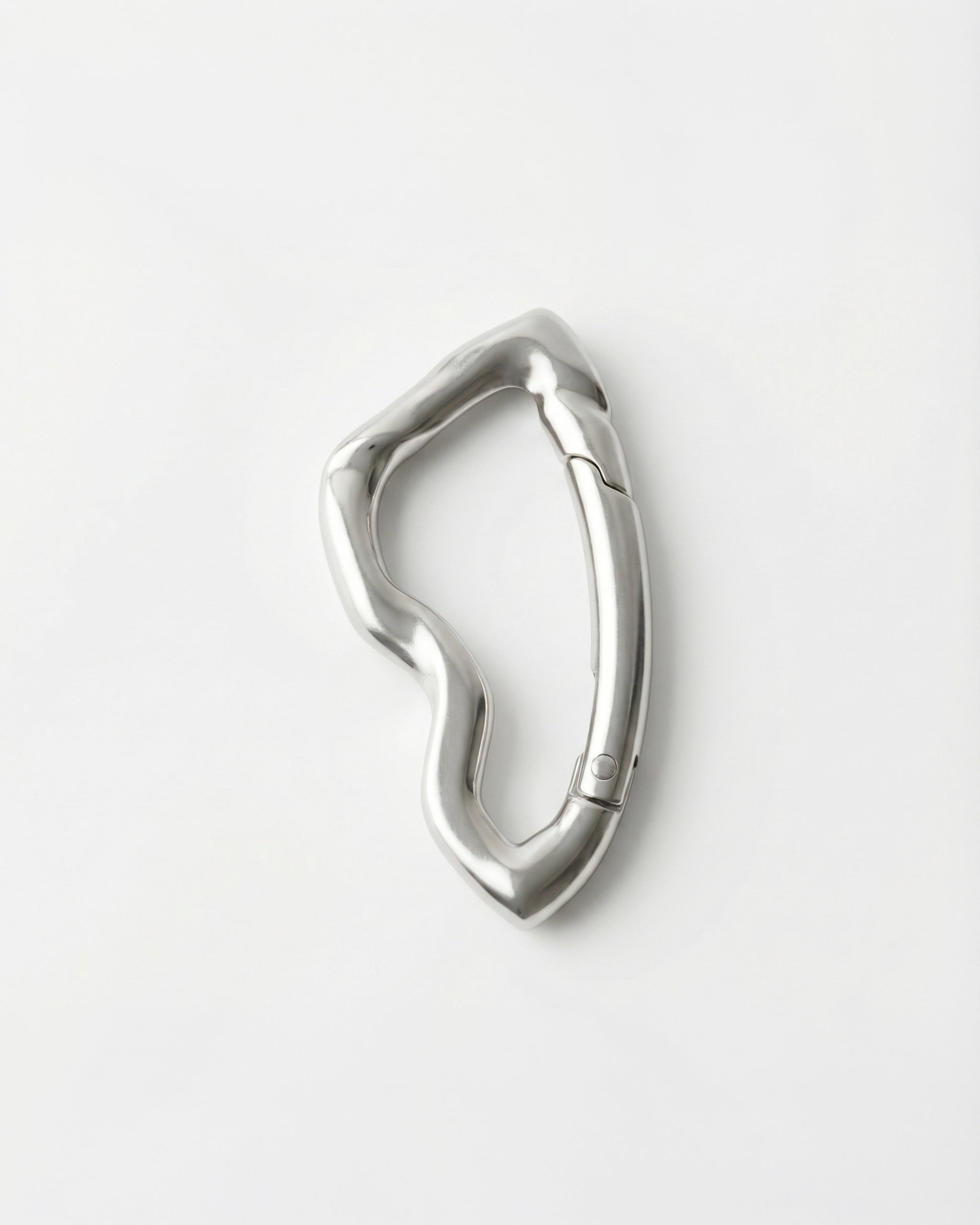 Wavy silver metal clip on a plain white background