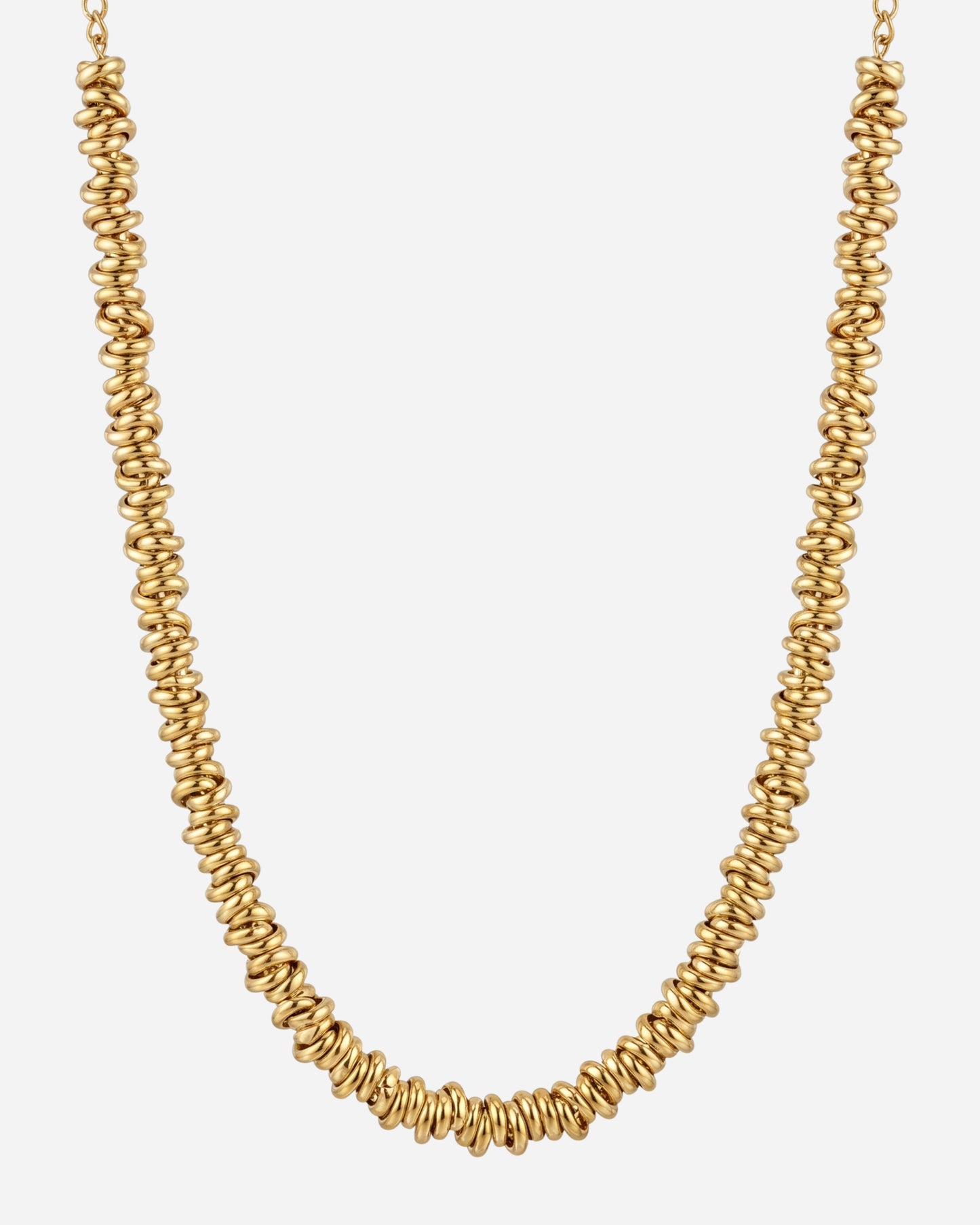 Gold necklace with spiral-shaped beads on a plain background